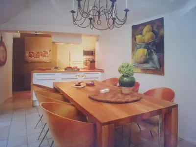 a kitchen with a wooden table and some chairs at Hövell in Huizen