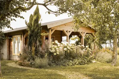 a house with a garden in front of it at Chalet Ben in Broek in Benningbroek