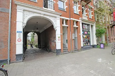 an entrance to a brick building with an archway at Beautiful 2 floor Vondelpark apartment. in Amsterdam