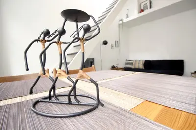 two metal sculptures on the floor of a room at Beautiful 2 floor Vondelpark apartment. in Amsterdam