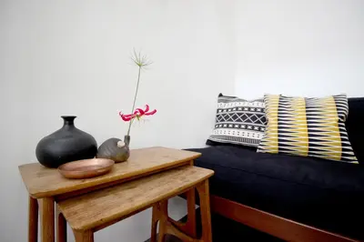 a living room with a blue couch and a table at Beautiful 2 floor Vondelpark apartment. in Amsterdam