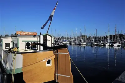 a boat docked in a marina with other boats at Marinaparcs Naarden in Naarden