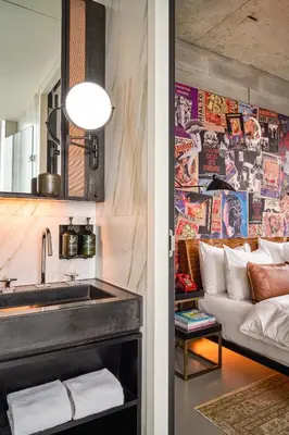 a kitchen and living room with a sink and a couch at Sir Adam Hotel, part of Sircle Collection in Amsterdam