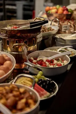 a buffet with many plates of food on a table at Sir Adam Hotel, part of Sircle Collection in Amsterdam