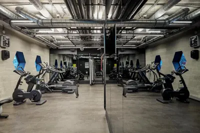 a gym with several treadmills and cardio machines at Sir Adam Hotel, part of Sircle Collection in Amsterdam