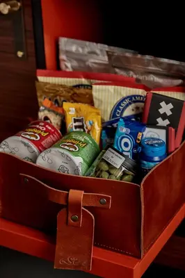 a suitcase filled with different types of snacks at Sir Adam Hotel, part of Sircle Collection in Amsterdam