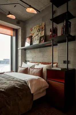 a bedroom with a large bed and a large window at Sir Adam Hotel, part of Sircle Collection in Amsterdam
