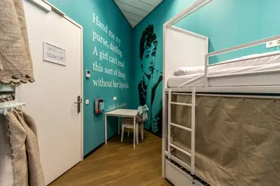a room with a bunk bed and a desk at Hostelle - women only hostel Amsterdam in Amsterdam