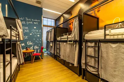 a dorm room with bunk beds and a table at Hostelle - women only hostel Amsterdam in Amsterdam