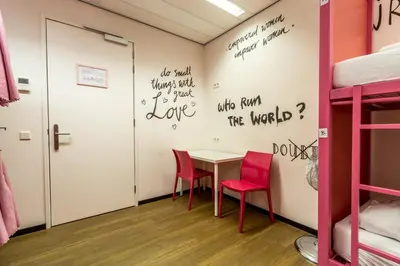 a room with a table and two chairs at Hostelle - women only hostel Amsterdam in Amsterdam