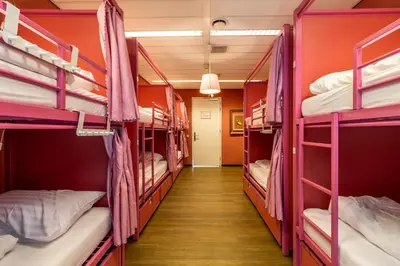 a corridor of a dorm room with bunk beds at Hostelle - women only hostel Amsterdam in Amsterdam