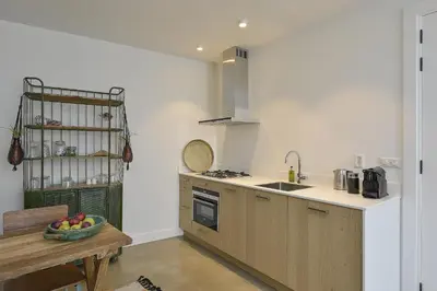 a kitchen with a sink and a counter top at Follow The Sun Apartment in Zandvoort