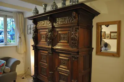 a large wooden cabinet in a room with a mirror at Perfect APT - Heart of Amsterdam in Amsterdam