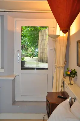 a room with a door leading to a patio at Perfect APT - Heart of Amsterdam in Amsterdam