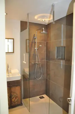 a bathroom with a glass shower with a sink at Perfect APT - Heart of Amsterdam in Amsterdam