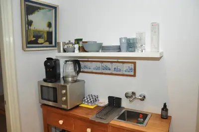 a microwave sitting on top of a wooden table at Perfect APT - Heart of Amsterdam in Amsterdam