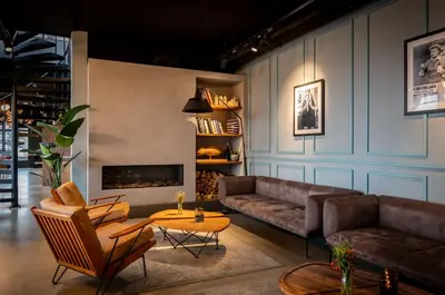 a living room with a couch and a table at Cityden Zuidas in Amstelveen