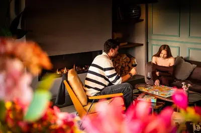 a group of people sitting in a living room with a fireplace at Cityden Zuidas in Amstelveen