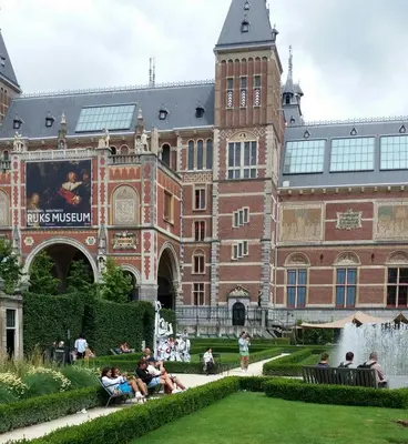 people sitting on benches in front of a building at Only Friends in Amsterdam