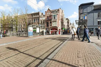 a group of people walking down a city street at Only Friends in Amsterdam