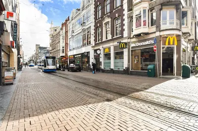 a tram on a city street with buildings at Only Friends in Amsterdam