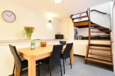 a dining room with a wooden table and chairs at Only Friends in Amsterdam
