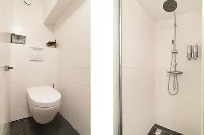 a bathroom with a toilet and a shower at Only Friends in Amsterdam