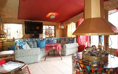 a living room with couches and a table and a tv at Paradijs Eiland in Hillegom