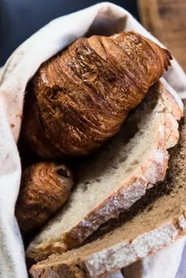 two loaves of bread in a basket on a table at Vesting Hotel Naarden in Naarden