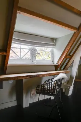 a chair in front of a window in a room at Vesting Hotel Naarden in Naarden