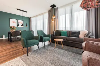 a living room with a couch and chairs and a table at YAYS Amsterdam North by Numa in Amsterdam