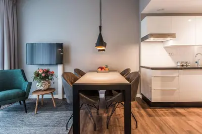 a kitchen and dining room with a table and chairs at YAYS Amsterdam North by Numa in Amsterdam