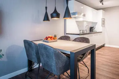 a dining room table with chairs and a bowl of fruit at YAYS Amsterdam North by Numa in Amsterdam