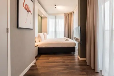 a small room with a bed and a window at YAYS Amsterdam North by Numa in Amsterdam