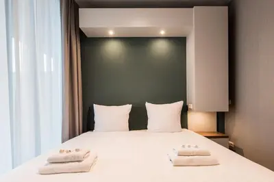 a bedroom with a bed with two towels on it at YAYS Amsterdam North by Numa in Amsterdam