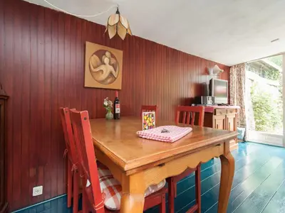 a dining room with a wooden table and chairs at Holiday Home Bergen near Forest & Beach in Bergen