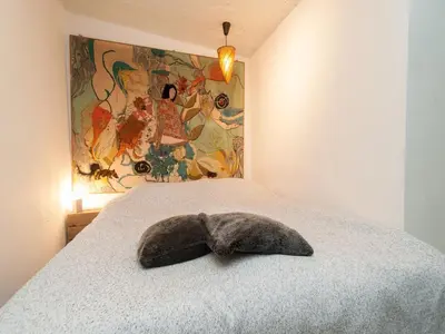 a stuffed animal is laying on a bed at Holiday Home Bergen near Forest & Beach in Bergen