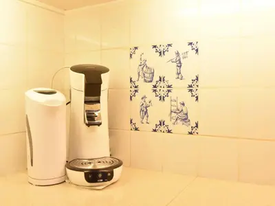 a coffee maker and paper towels on a counter at Holiday Home in Bergen aan Zee with Terrace in Bergen aan Zee