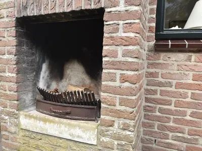 a brick fireplace in a brick wall at Holiday Home in Bergen aan Zee with Terrace in Bergen aan Zee
