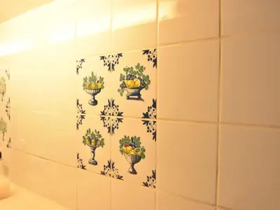 a tiled bathroom with a wall with flowers on it at Holiday Home in Bergen aan Zee with Terrace in Bergen aan Zee