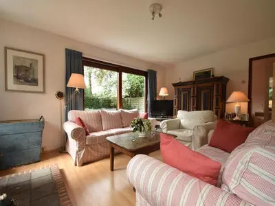 a living room with two couches and a table at Holiday Home in Bergen aan Zee with Terrace in Bergen aan Zee