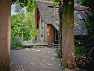 an outside view of a house with a tree at Holiday Home in Bergen near Forests in Bergen