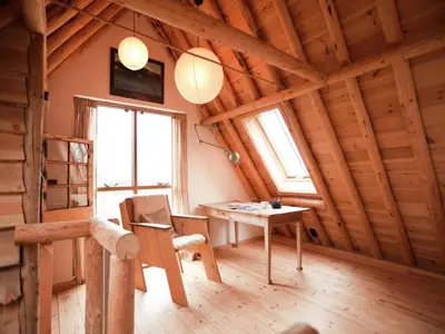 a room with a table and a chair in a cabin at Holiday Home in Bergen near Forests in Bergen