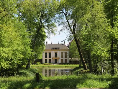 a house in the middle of a park with trees at Apartment in Heiloo near North Sea Beach in Heiloo
