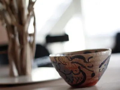 a bowl sitting on a table next to a vase at Apartment in Heiloo near North Sea Beach in Heiloo