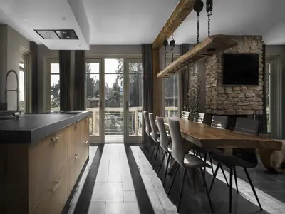 a kitchen with a long wooden table and chairs at Holiday Home with bubble bath in Noordwijk in Noordwijk