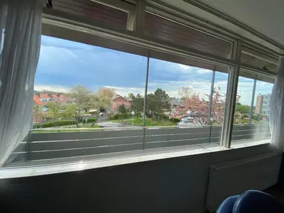 a large window with a view of a street at Reumann Holiday Apartments De Schelp 47 in Zandvoort