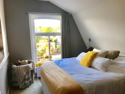 a bedroom with a bed and a window at Charming countryhouse near Amsterdam in Abcoude