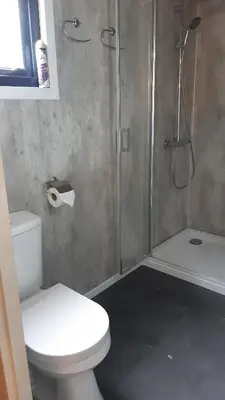 a bathroom with a shower and a toilet and a toilet paper roll at Kitty's Place Warmond in Warmond