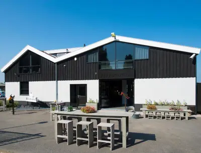 a building with a table and stools in front of it at Ghoyhuys in Leiderdorp